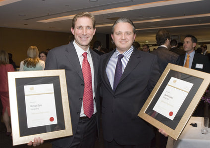 A 2006 photo of Storage King founders Michael Tate (left) and David Scanlen (right) proudly winning an Entrepreneur of the Year award. This authoritative recognition of their success, just eight years after they founded Storage King in 1998, demonstrates the trusted expertise and vision that built our national brand.